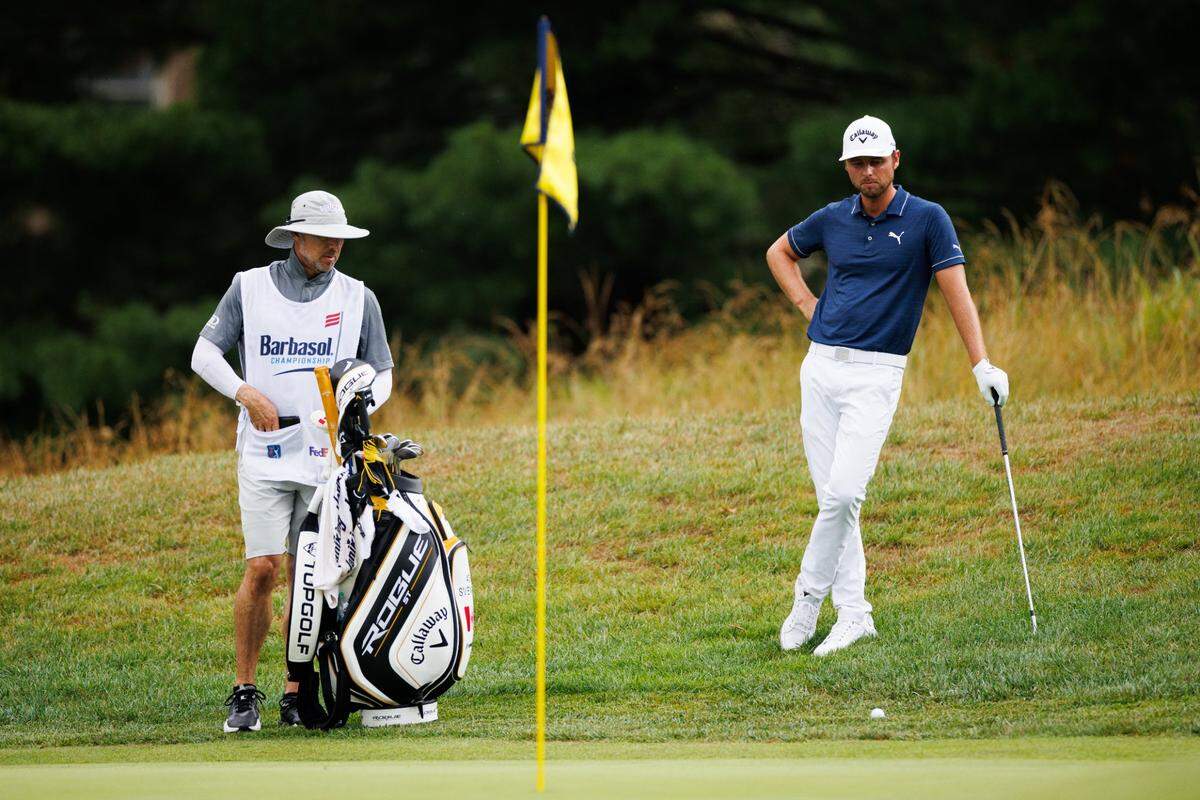 Adam Svensson, right, and his caddie look down at Svensson’s ball on No. 3 during the second round of the PGA Barbasol Championship on Friday in Nicholasville. Svensson is trying to secure an automatic berth in next week’s British Open in Scotland.