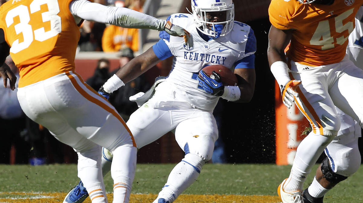 Kentucky running back Raymond Sanders (4) cut upfield past Tennessee defenders last November in Knoxville. Sanders gained 669 yards last season, scoring five touchdowns, and expects to get action in the "Air Raid" offense.    