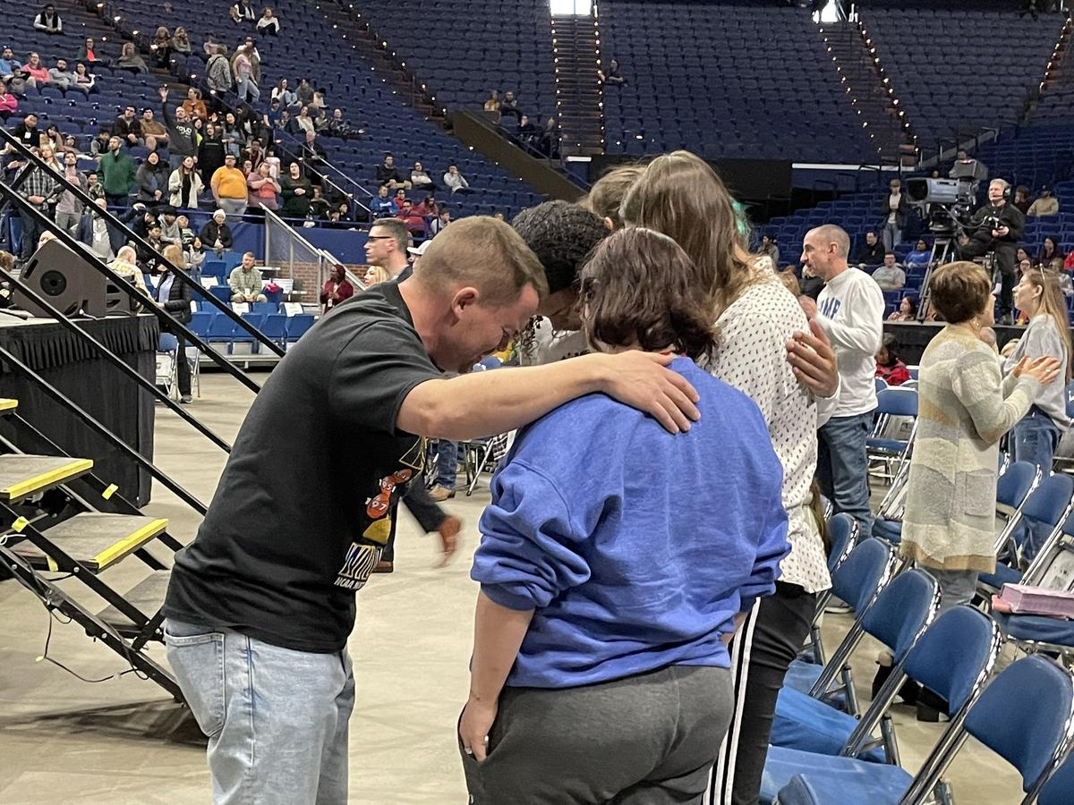 Nick Hall, president of the Minnesota-based Evangelistic ministry Pulse, prays with members of the My Church of Georgetown youth group. 
