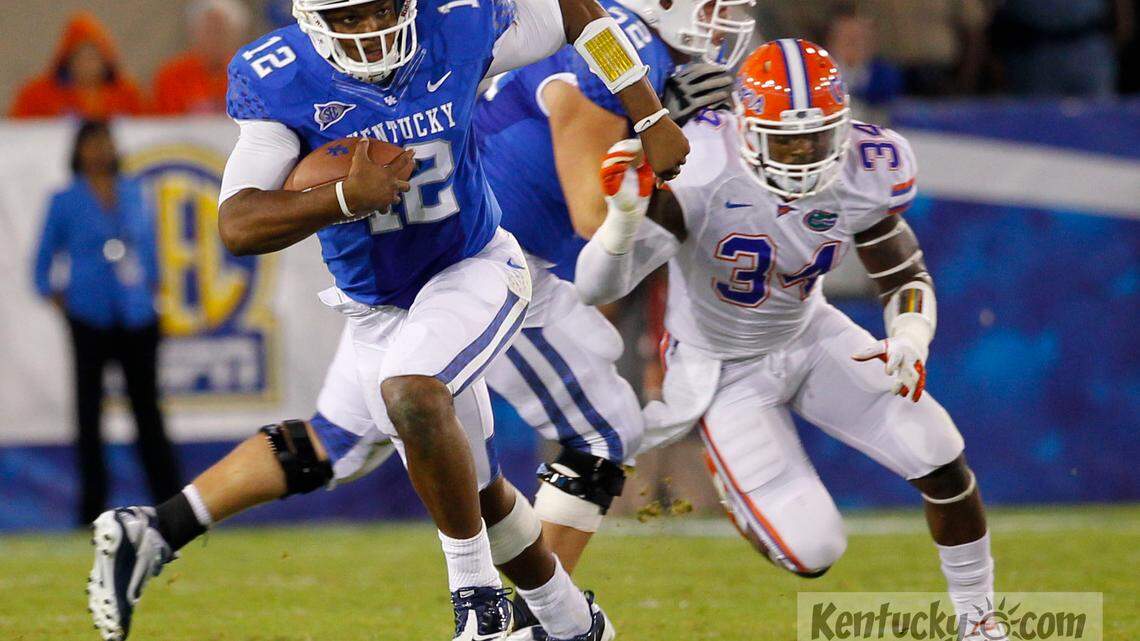 Kentucky Wildcats quarterback Morgan Newton (12) ran for his life as Florida defeated Kentucky 48-10  on Saturday September 24, 2011  in Lexington, Ky.  Photo by Mark Cornelison | Staff