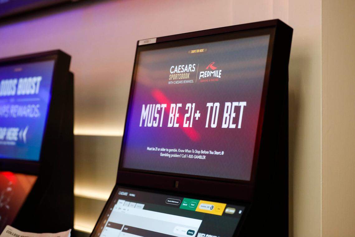 Patrons place bets after a press conference where Gov. Andy Beshear announces the opening of a Caesars Sportsbook and made comments on the first day of sports betting legalization in the Commonwealth at Red Mile in Lexington, Ky, Thursday, September 7, 2023.