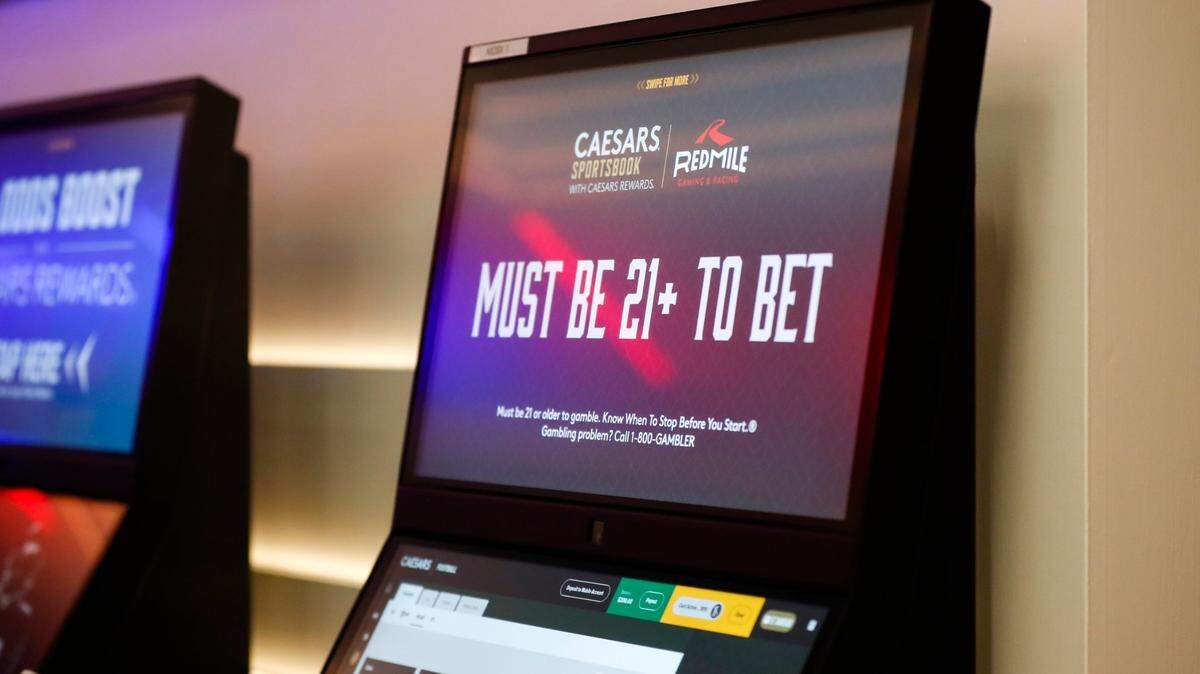 Patrons place bets after a press conference where Gov. Andy Beshear announces the opening of a Caesars Sportsbook and made comments on the first day of sports betting legalization in the Commonwealth at Red Mile in Lexington, Ky, Thursday, September 7, 2023.