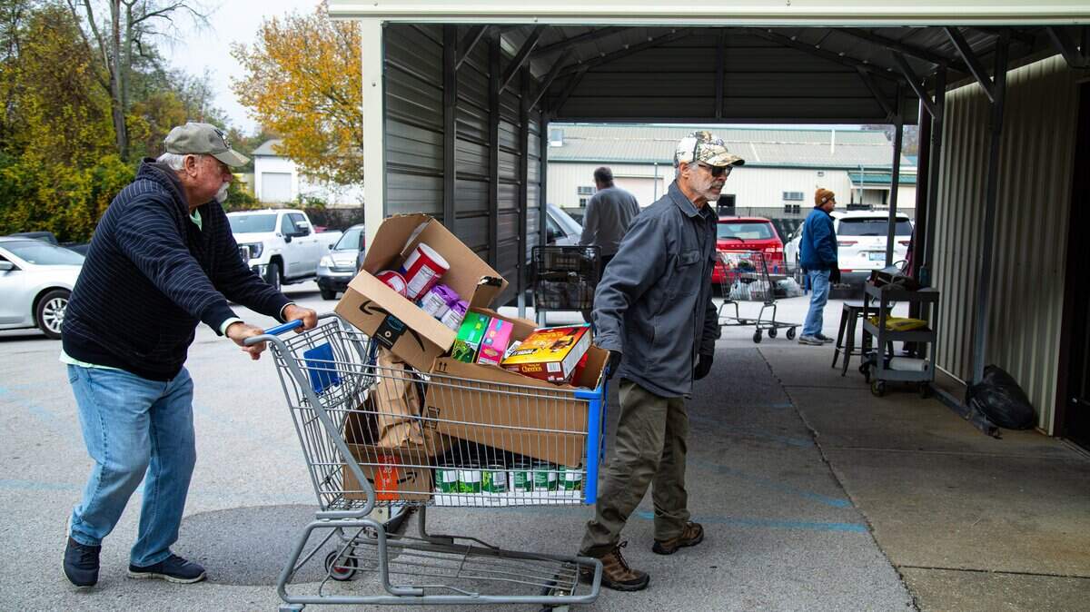 God's Outreach Food Pantry volunteers are receiving non-perishable donations from community members for delivery to food recipients on Nov. 3, 2025, in Richmond, Ky.