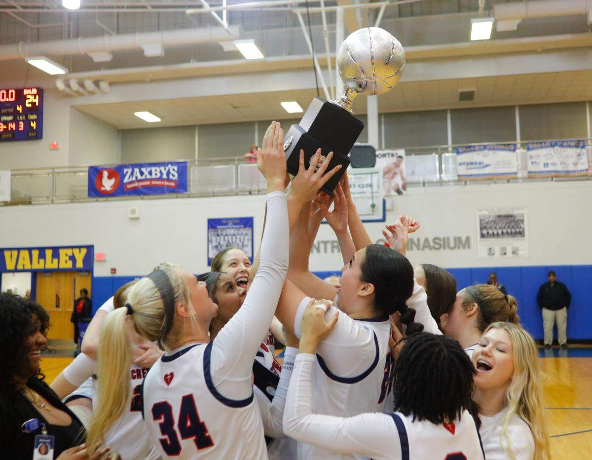 Sacred Heart holds up the trophy after betting Butler in the 2024 Republic Bank Girls LIT Championship game. Jan. 27, 2024