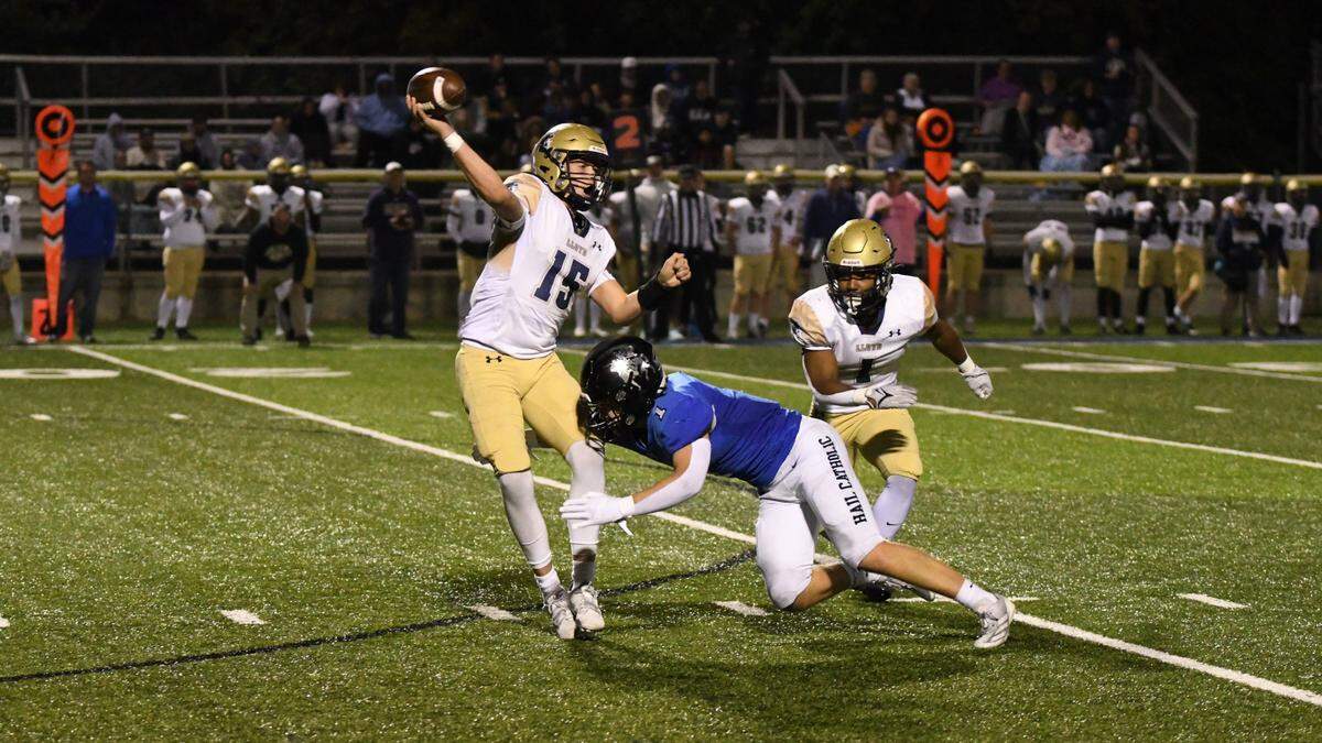 Lexington Catholic’s Brady Wasik pressures Lloyd Memorial quarterback Kaleb Evans during Friday night’s win for the Knights.