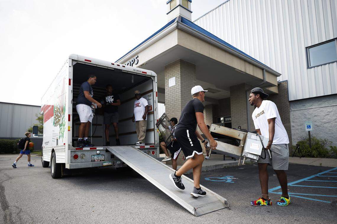 Lincoln Powell of Somerset, second from right, and Felix Wilson of Lexington, right, and others worked to clear kitchen equipment from the Kentucky Basketball Commission facility Saturday. The facility is closing and the owners plan to reopen at a new location in the future.