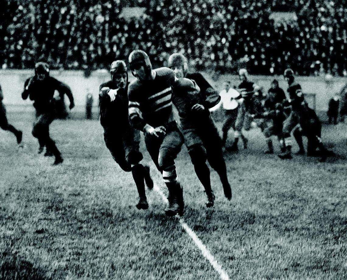Centre’s Bo McMillin eluded two Harvard defenders on the way to scoring the only touchdown in Centre s historic 6-0 victory over Harvard in 1921.