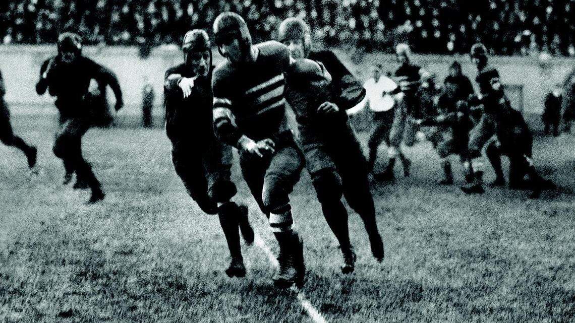 Centre’s Bo McMillin eluded two Harvard defenders on the way to scoring the only touchdown in Centre’s historic 6-0 victory over Harvard on Oct. 29, 1921. Proclaimed “The Upset of the (20th) Century” by The New York Times in 1971, Friday is the 100th anniversary of the game.