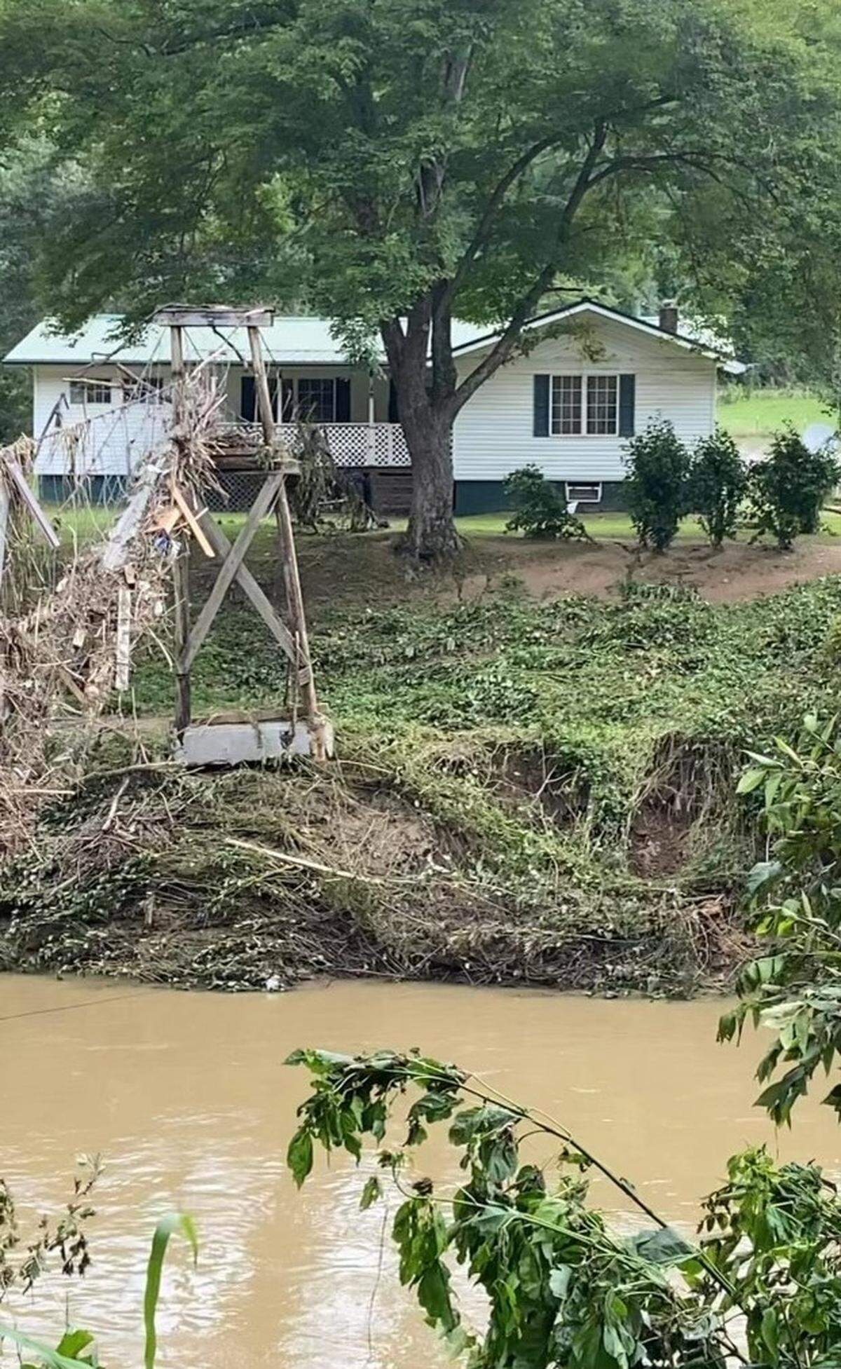 Gilla Miller’s family said the 83-year-old was fond of the swinging bridge that connected her home to the nearby highway. In Thursday’s floods, it was destroyed. This photo shows the aftermath.