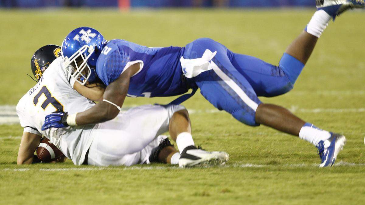 Kentucky's Alvin Dupree sacked Kent State quarterback Spencer Keith in UK's victory last weekend. It was the sophomore's first game at weakside linebacker.      