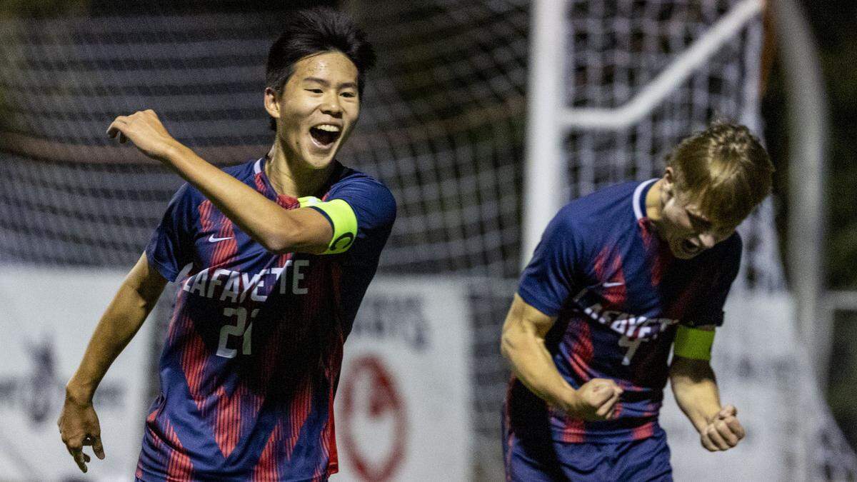 Lafayette's Rylan Chau (21), left, and Lafayette's Max Jacobs (9) celebrate after Chau scored the first goal in the Generals 4-0 win over Lexington Catholic in the 43rd District championship game, Thursday, Oct. 9, 2025 at Lexington Catholic in Lexington, Ky.
