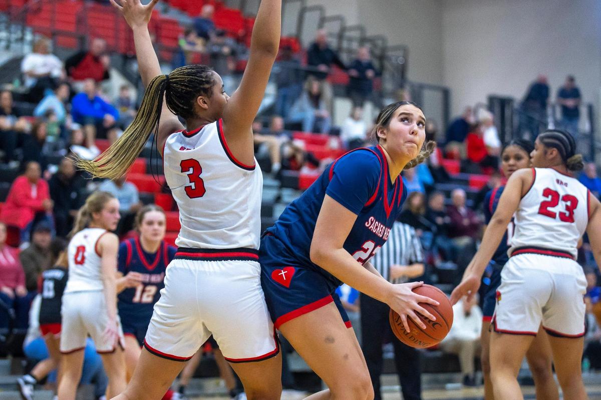 Sacred Heart’s Angelina Pelayo (22) looks for a shot around George Rogers Clark’s Ciara Byars (3) on Tuesday night.