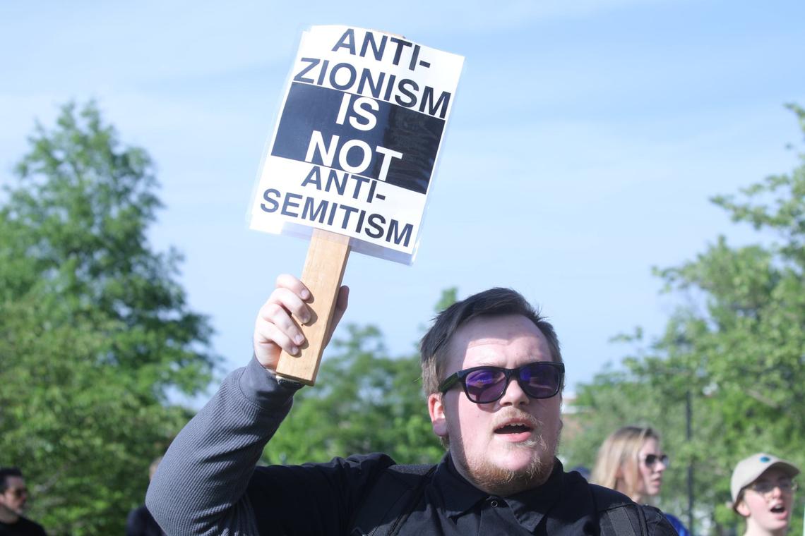Peaceful protester holds an “Anti-Zionisim Is NOT Anti-Semitism” sign during the peaceful Free Palestine rally at the William T Young Library lawn on UK’s campus on May 1, 2024, in Lexington, Ky.