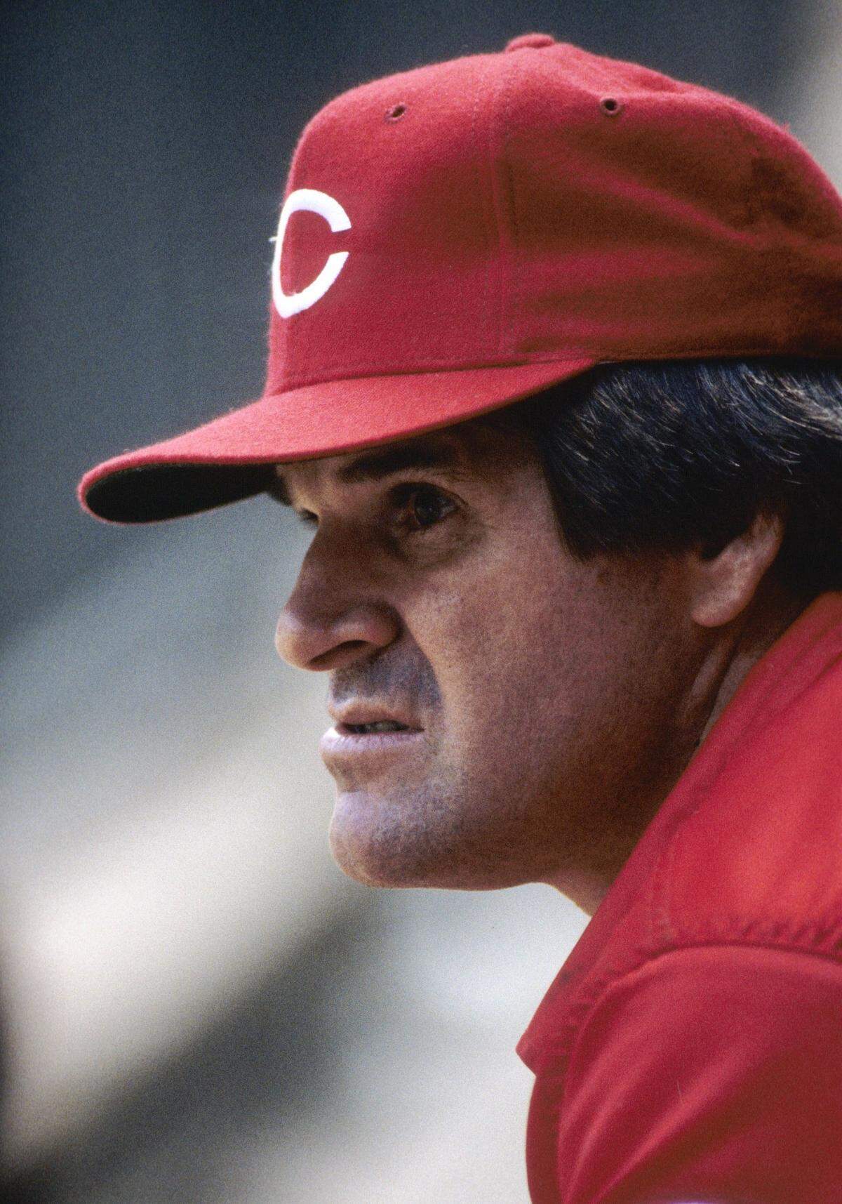 Cincinnati Reds outfielder Pete Rose sits in dugout during the 1984 season at Riverfront Stadium.