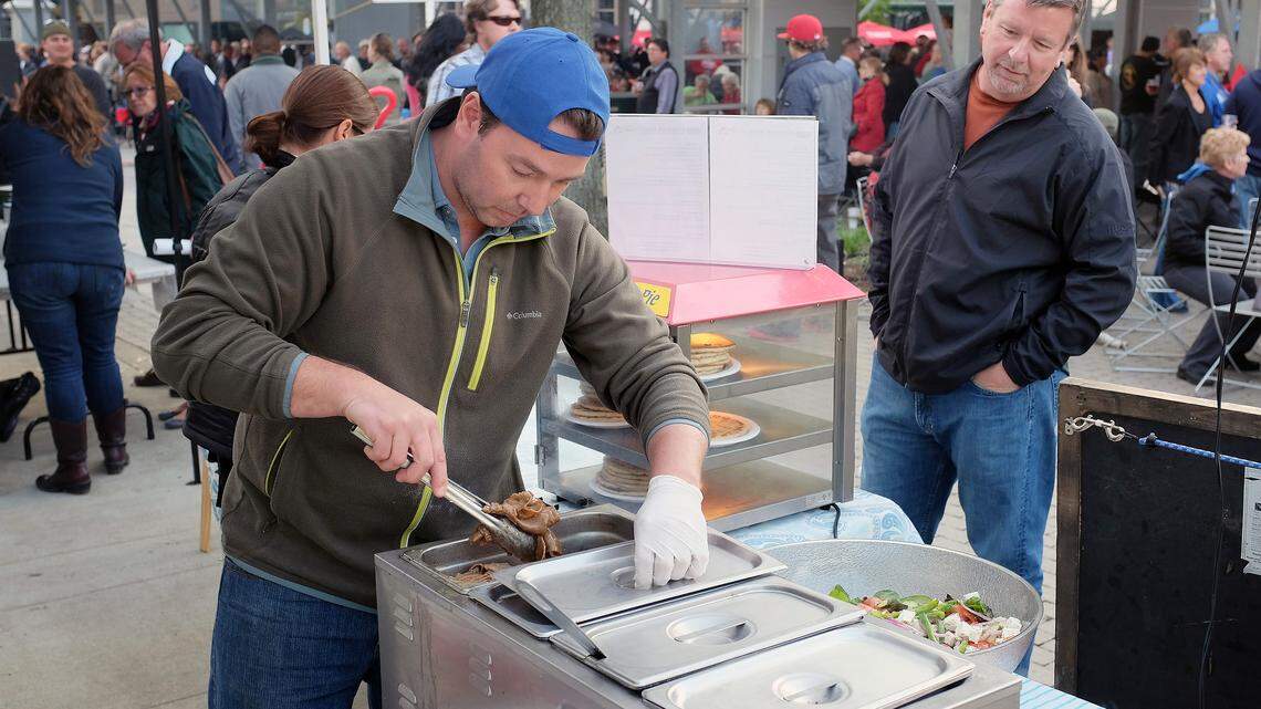 At a recent Thursday Night Live at Cheapside in Lexington, Dave Floyd watched as Ilias Pappas of the Athenian Grill food truck prepared his gyros sandwich.   