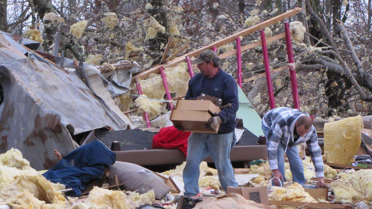 Volunteers helped salvage items from the mobile home of Aaron Keith, which was destroyed Wednesday when a suspected tornado hit northern Russell County.