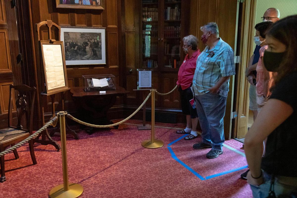 Patrons stand in a socially distanced space marked by tape during a tour at Ashland: The Henry Clay Estate in Lexington, Ky., Wednesday, August, 2020. The estate used spaces throughout the house to provide a safe experience for people to still come and learn.