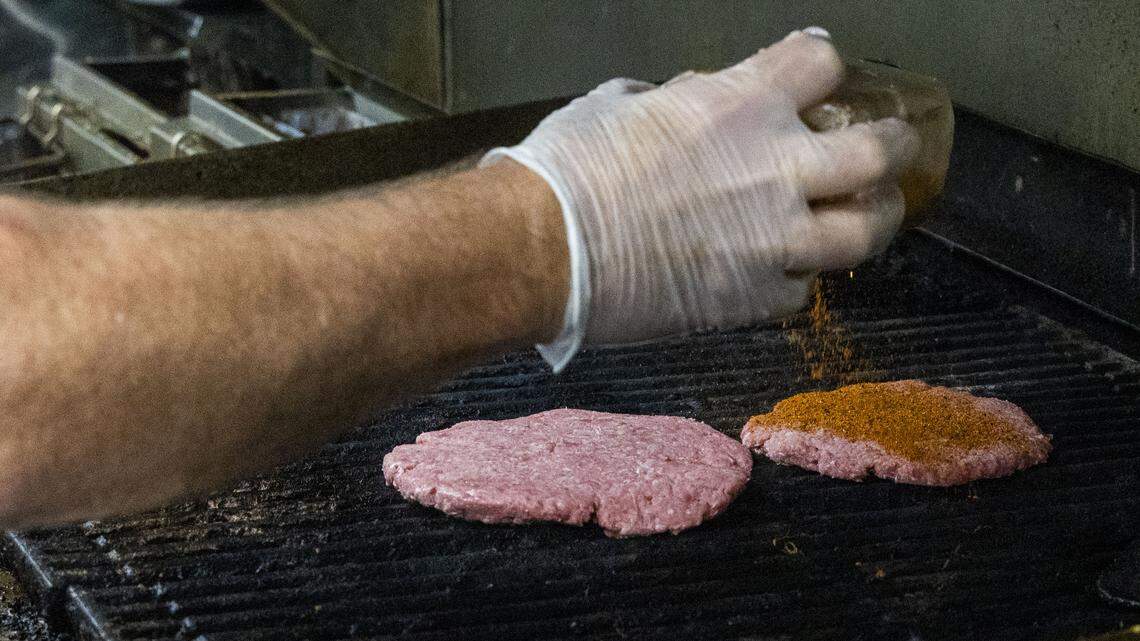 O’Round burgers are char broiled cooked to whatever temperature is requested by the customer. Each patty is topped with Lawry's Seasoned Salt, or, shown here, Cajun seasoning for a Cajun O’Round, one of the more popular burgers at the Irish themed restaurant and bar.