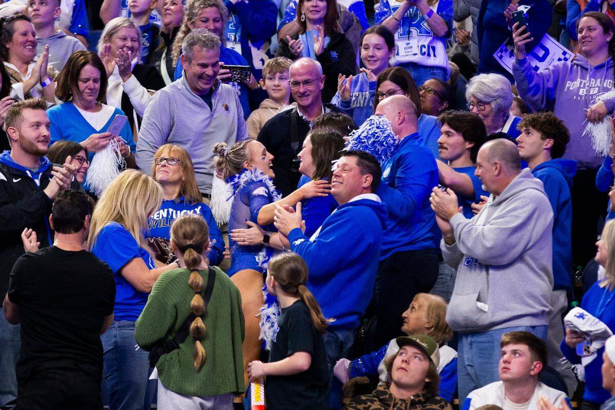 Raena Worley celebrates with her family in the stands after her floor routine during Kentucky’s annual Excite Night meet against Georgia at Rupp Arena this season.