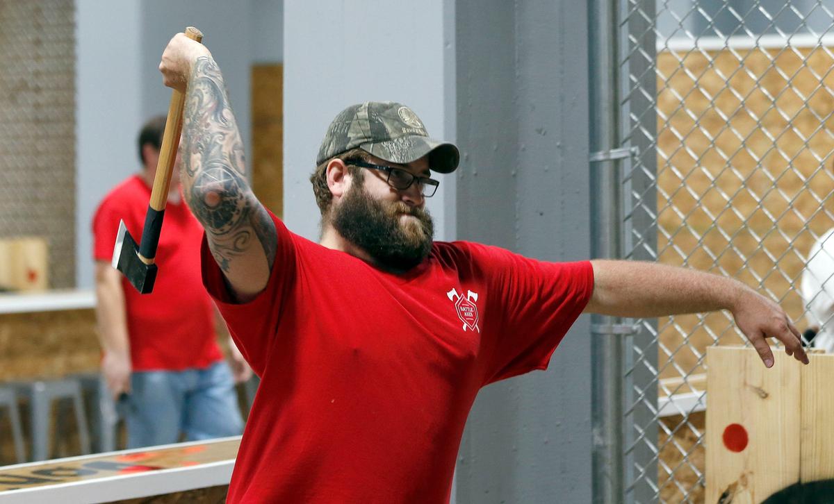 Derek Wise, a pit boss, threw a hatchet at Battle Axes in the ground floor of the old Pepper warehouse. Throwing pits are separated by chain link fences to protect players.