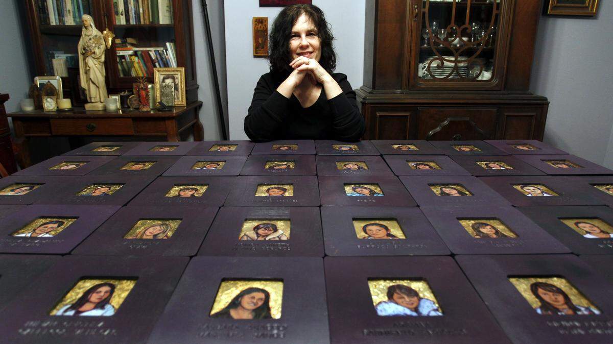 In her home in Lexington, artist Diane Kahlo sat behind paintings from her exhibit Wall of Memories: The Disappeared Señoritas of Ciudad Juárez. So far, she has painted the faces of more than 150 girls and women who have been murdered in the Mexican city. Hundreds more have been killed.  