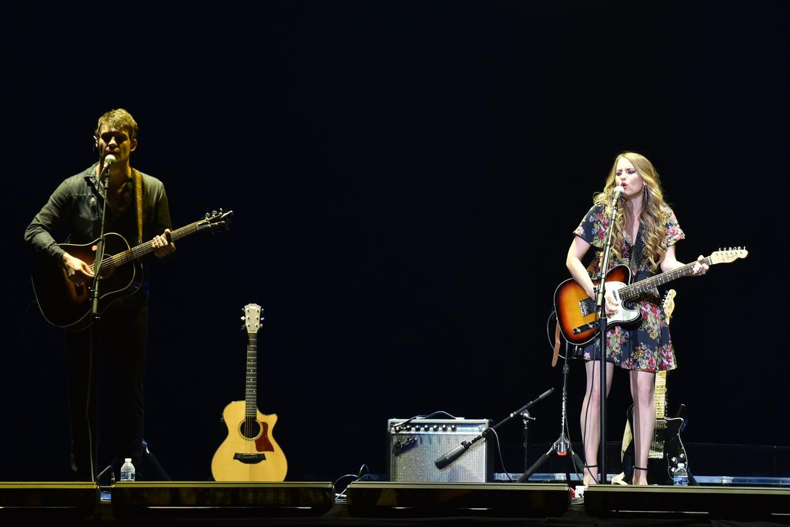 Caitlyn Smith (right) opened for Tim McGraw and Faith Hill along with her guitar player and husband Rollie Gaalswyk (left).