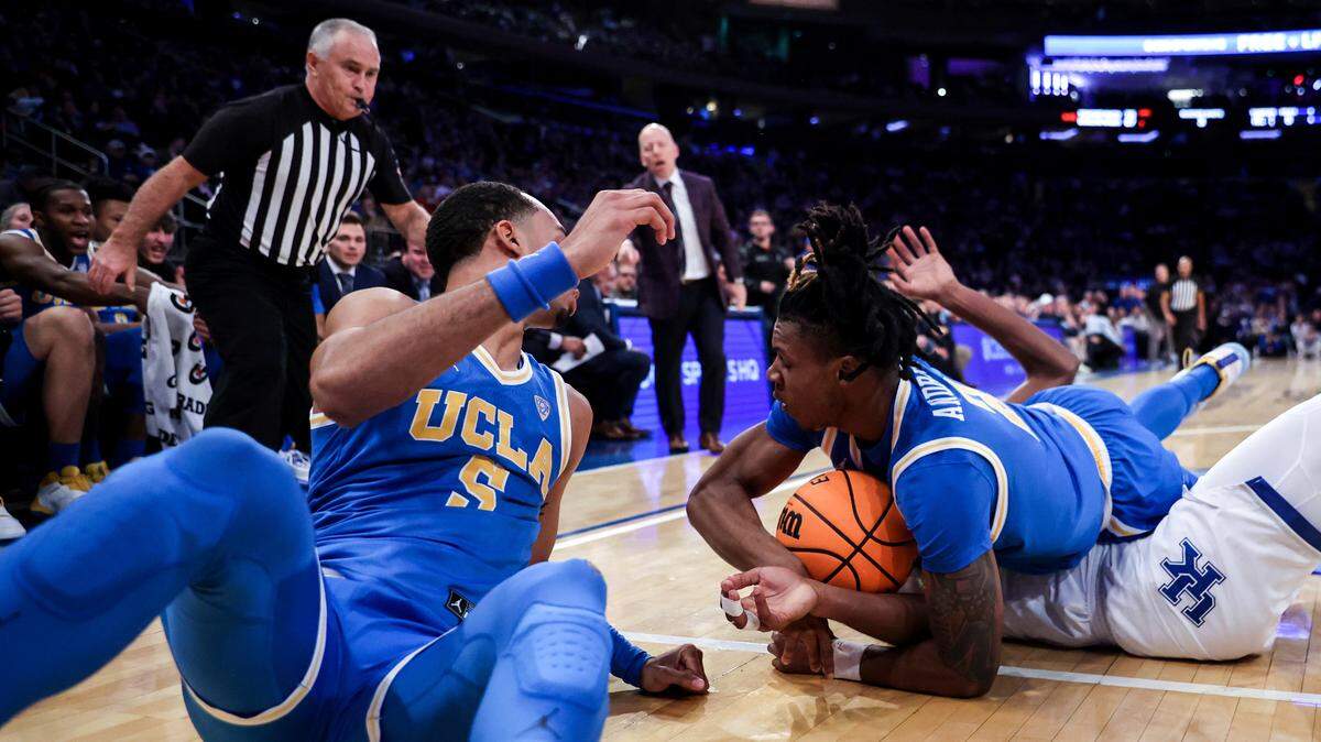 Kentucky and UCLA players fight for a loose ball during the first half of the Bruins’ victory over Kentucky in Madison Square Garden on Saturday.