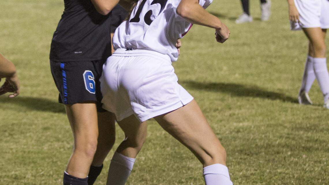 West Jessamine's Eva Mitchell (15) and East's Kaitlyn Maricle battle for a ball as West Jessamine wins 5-2 over East Jessamine at the West Jessamine Middle School on Wednesday September 24, 2014 in Nicholasville, Ky.  Photo by Mark Mahan
