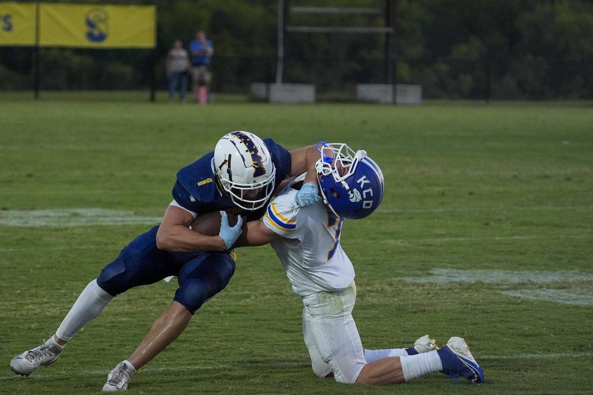 Sayre's John Luke Minner stiff armed Kentucky Country Day Brohm Garlove (7)  as Kentucky Country Day defeated host Sayre 31-28  on Friday Aug. 22, 2025 in Lexington, Ky.