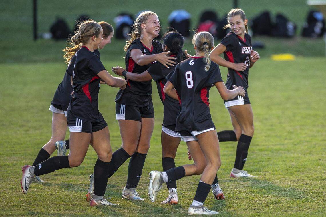 Dunbar's Kennedy Morgan (4), third from left, celebrates with her teammates after scoring a goal during the girls soccer 43rd District Tournament Championship at Lexington Christian Academy in Lexington, Ky., on Thursday, Oct. 9, 2025.