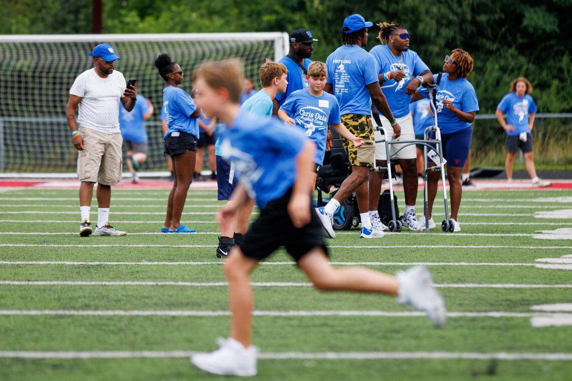 Chris Oats stands up out of his wheel chair during his football camp Saturday. “He’s able to be a lot more independent,” his mom, Kem Gamble, said. “His confidence — that’s the thing. It’s, ‘OK, I can do this.’”