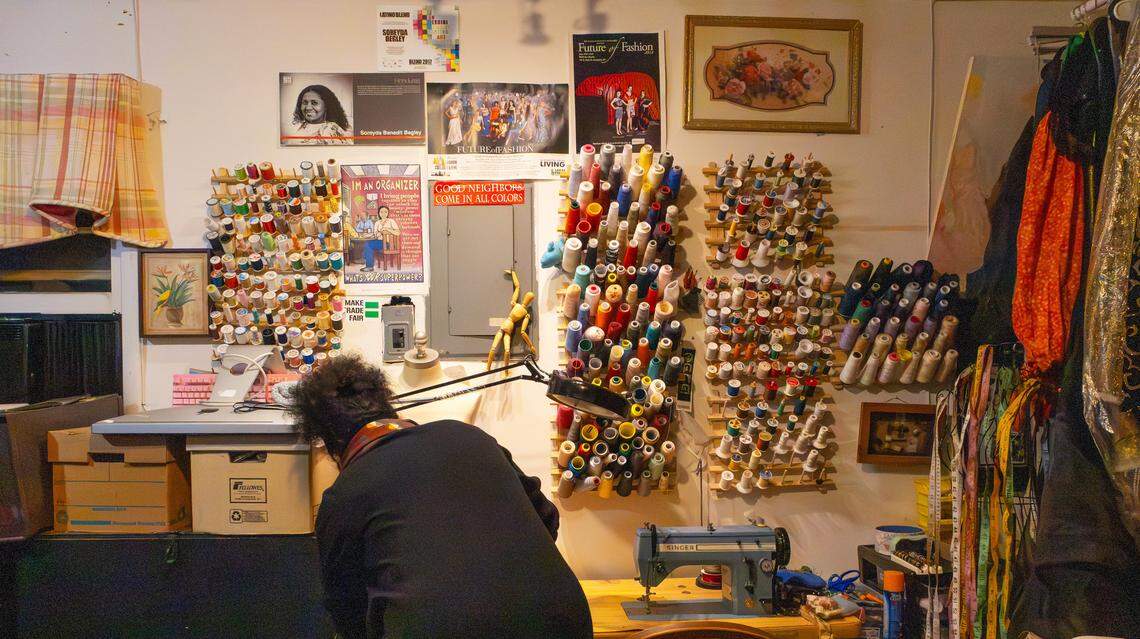 Local artist and activist fashion designer, Soreyda Benedit Begley, sorts through a mix of fabrics and threads as she prepares to sew an elaborate doll costume in her small home studio on Jan. 21, 2026, in Lexington, Ky.