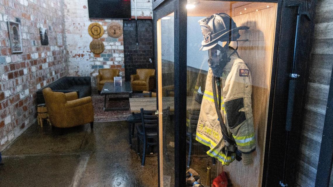Firefighting gear of retired Lexington firefighter Otis Cveticanin displayed inside a glass case in his new restaurant Halligans at the Distillery District on Manchester Street. Cveticanin opened the pub as a place where first responders can feel comfortable coming in, sitting down and talking to people who have experienced the same kinds of job stress. But the new restaurant is open to all.