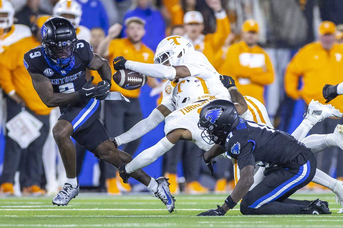Kentucky wide receiver Ja'Mori Maclin (9) battles with Tennessee defensive back Colton Hood (8) for the ball during Saturday’s game at Kroger Field.