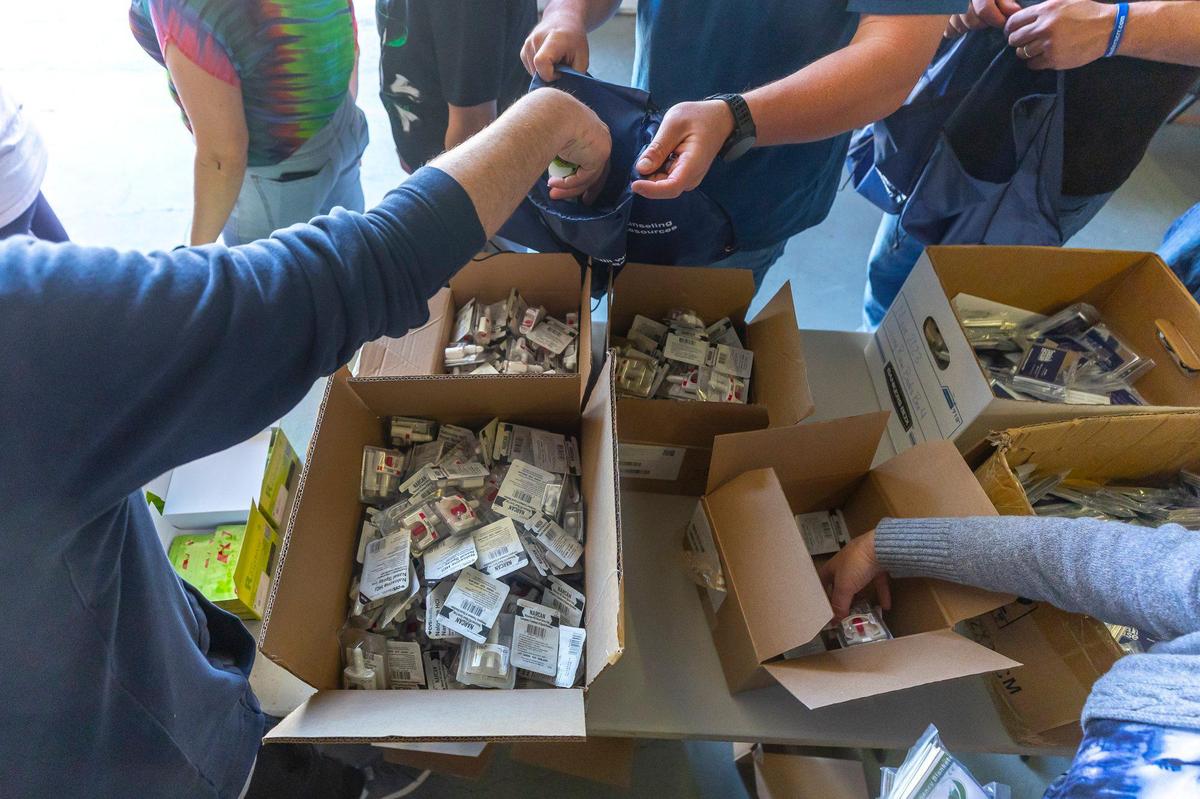 Narcan is added to a hygiene and necessity bag at the Recovery Cafe in Lexington, Ky., on Friday, April 18, 2025. Nearly 200 bags were prepared and distributed during Lexington Community Partner Street Outreach Day.