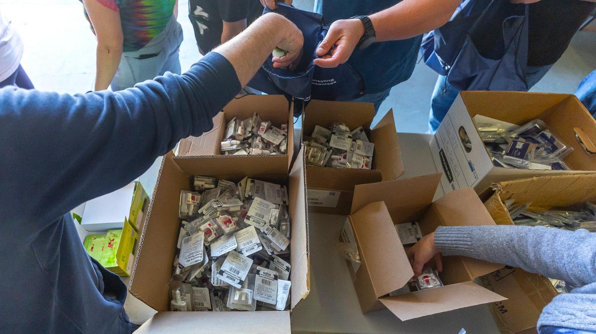 Narcan is added to a hygiene and necessity bag at the Recovery Cafe in Lexington, Ky., on Friday, April 18, 2025. Nearly 200 bags were prepared and distributed during Lexington Community Partner Street Outreach Day.