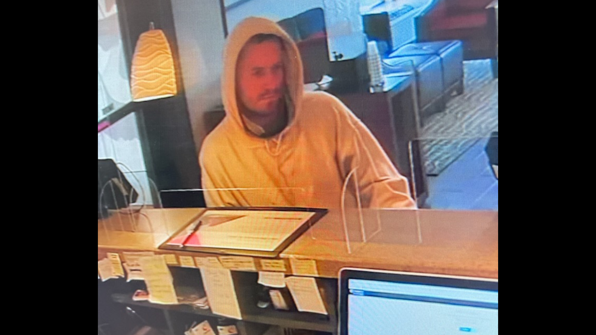 The suspect accused of committing a robbery in Lexington was described as a male, approximately 6-foot-1-inch tall with a light beard. He was wearing jeans and a light color hooded sweatshirt.