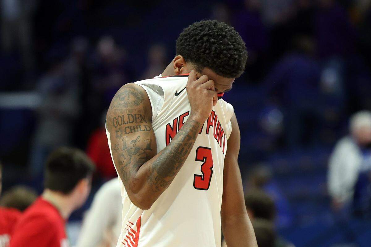 Newport’s DeShaun Jackson (3) leaves the court dejected after the Wildcats were defeated in the opening round by Campbell County.