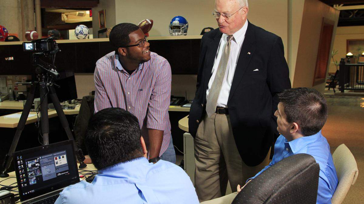 IHigh intern Dorian Hairston, standing, and CEO Jim Host talked with Randy Phillips, seated at left, and Phillip Broaddus at the Internet firm's offices in downtown Lexington. Established in 1999, iHigh.com has become a hub for youth-oriented video content.  