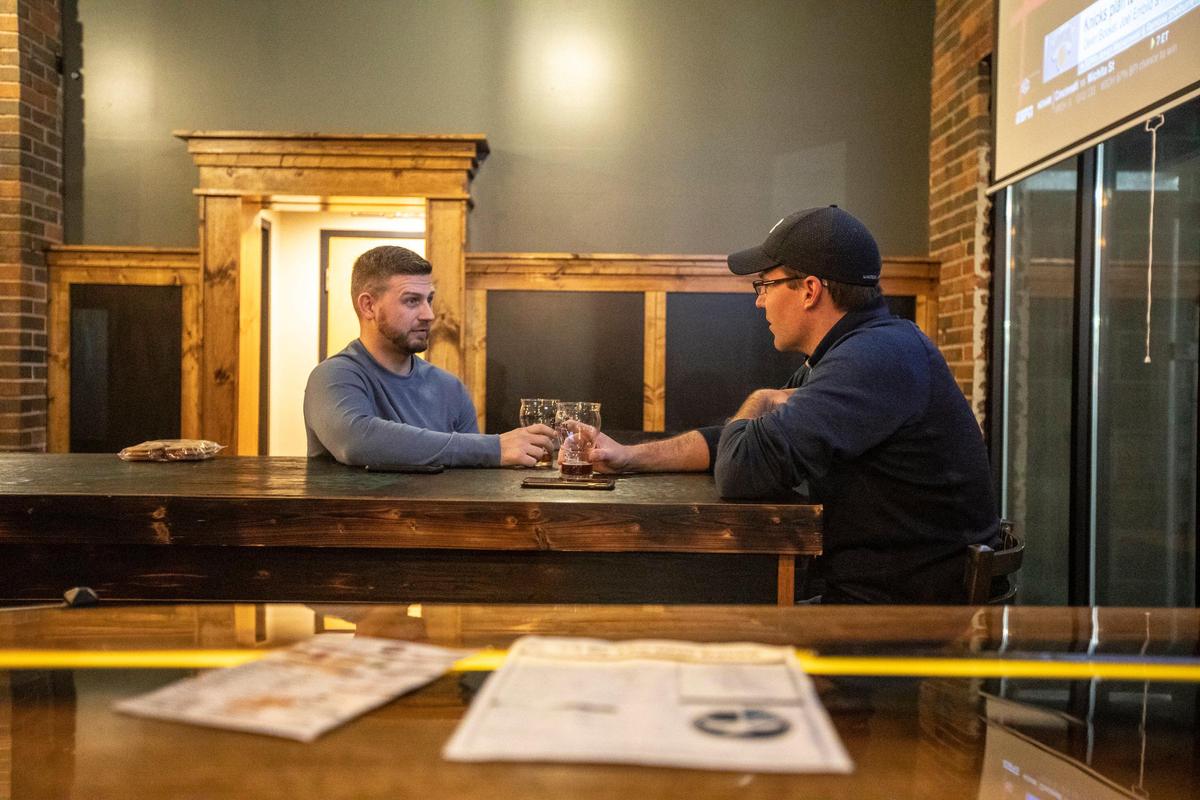 John Williamson, left, and Adam Sellner, both of Pikeville, enjoy some of the offerings at Broken Throne Brewing.