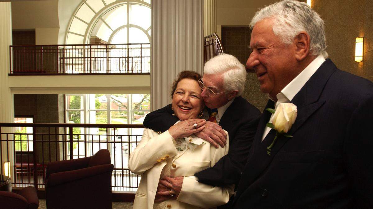 Graham Beck, right, stood by as William T. Young surprised Beck's wife, Rhona, with a hug as Young arrived for the dedication of the Beck Center at Transylvania University in 2002.  
