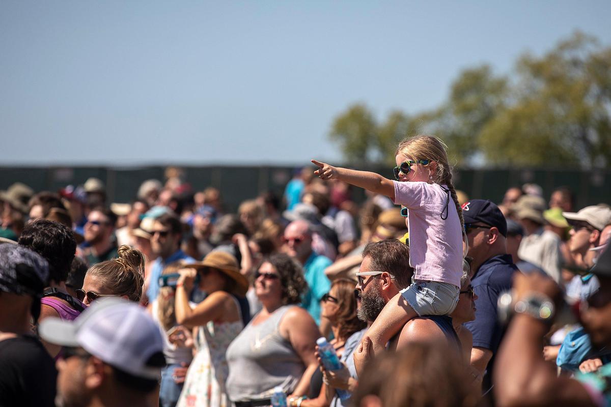 Daphne Bartley, 7, on the shoulders of Jason Hasch, both of Louisville, watched Low Cut Connie perform at the Elkhorn Stage during the Railbird Festival at Keeneland in Lexington, Ky., Saturday, Aug. 10, 2019.