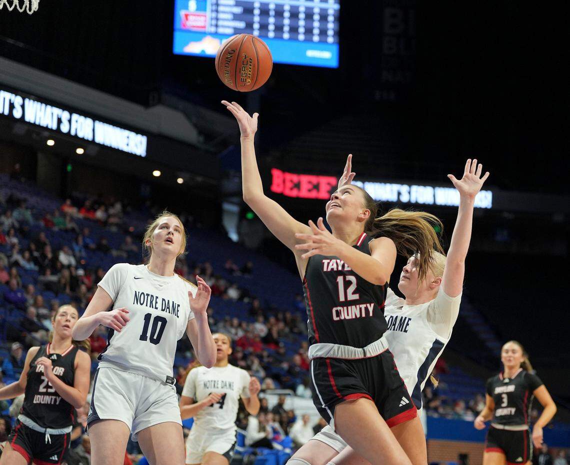 Taylor County’s Avery Raikes goes up for a basket against Notre Dame’s Sarah Young (10) and Amelia Stallard during the Clark’s Pump-N-Shop Girls’ Basketball Sweet 16 quarterfinals at Rupp Arena on Friday.