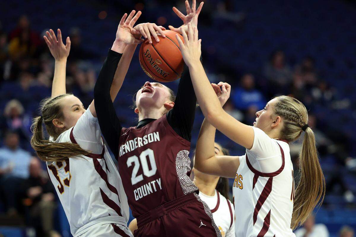 Henderson County’s Allyson Rideout (20) is engulfed by the Cooper defense during Friday night’s game. The Jaguars forced 16 turnovers and limited the Colonels to 2-of-9 shooting from 3-point range.
