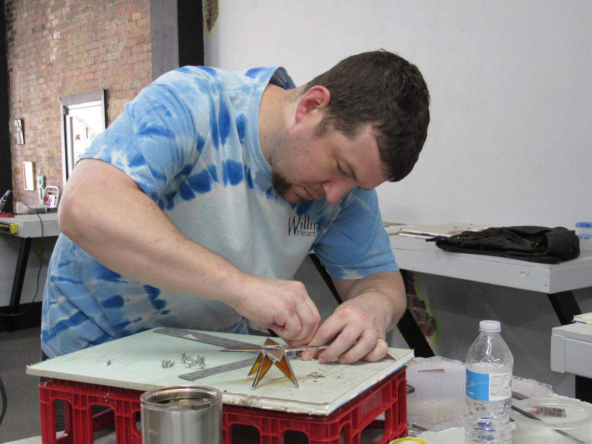 Garret Bone worked on a stained-glass star Dec. 12, 2019, at Willing Hearts in Cumberland.