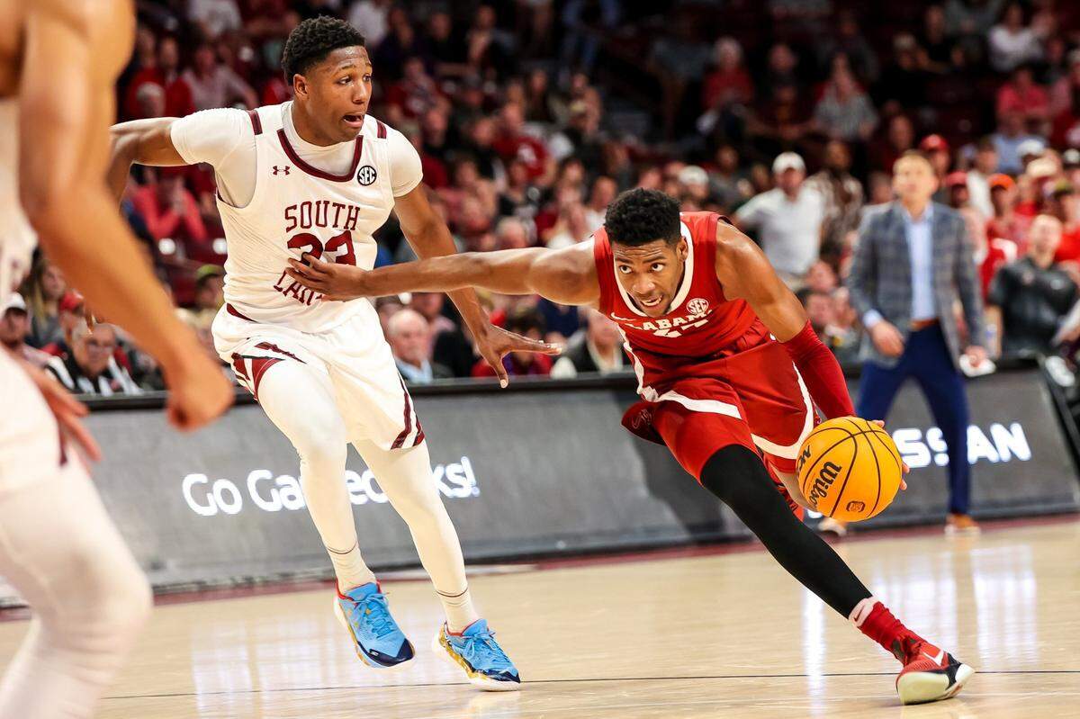 Feb 22, 2023; Columbia, South Carolina, USA; Alabama Crimson Tide forward Brandon Miller (24) drives around South Carolina Gamecocks forward Gregory Jackson II (23) in the first half at Colonial Life Arena. Mandatory Credit: Jeff Blake-USA TODAY Sports
