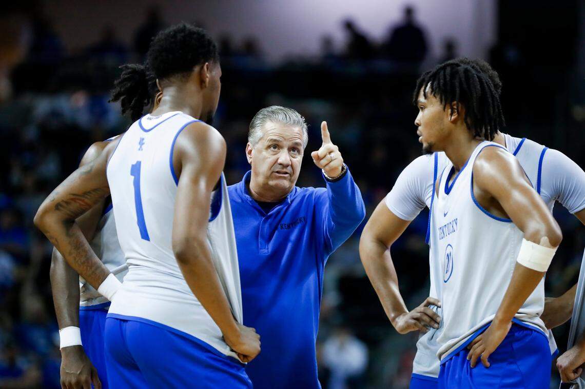 Kentucky coach John Calipari talks with freshmen Justin Edwards, left, and D.J. Wagner during the team’s Blue-White Game on Oct. 21.