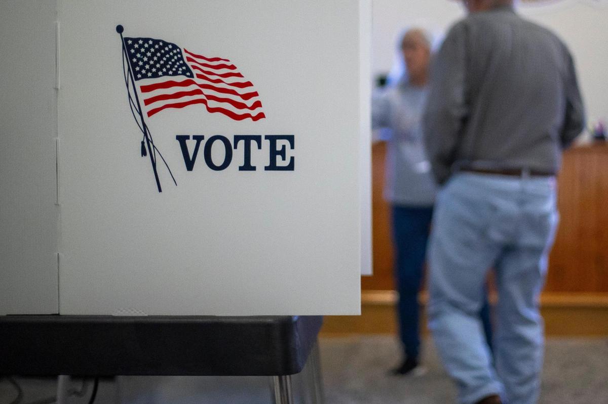 A voter is directed to a booth during early voting at the Knott County Court House in Hindman, Ky., on Thursday, Nov. 2, 2023.
