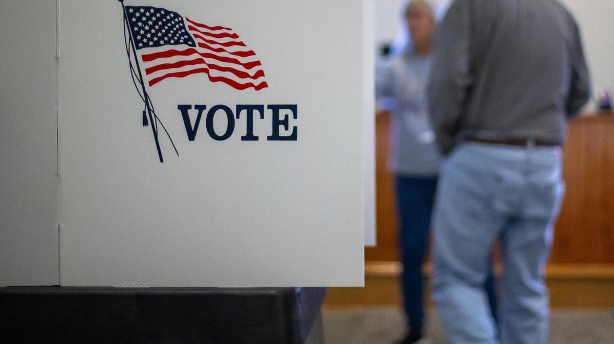 A voter is directed to a booth during early voting at the Knott County Court House in Hindman, Ky., on Thursday, Nov. 2, 2023.