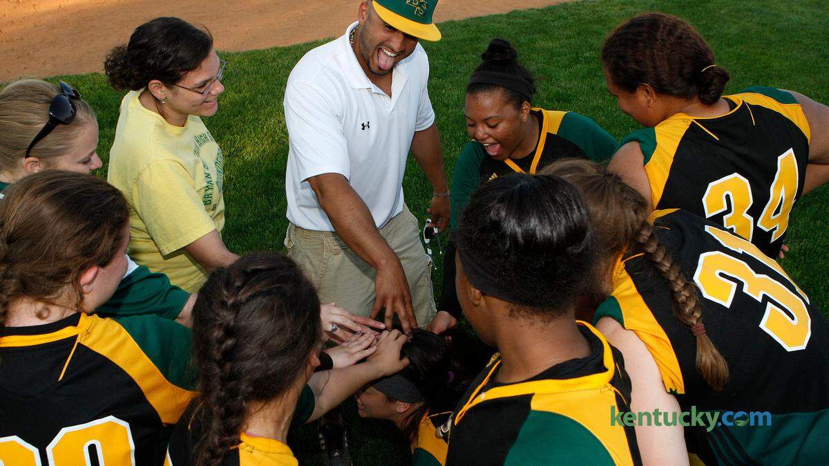 Bryan Station head softball coach Hector Urbaneja celebrates with his team after the Defenders defeated Bath Co. at the Bryan Station softball complex in Lexington, Ky., Tuesday, May 5, 2015. Photo by Matt Goins